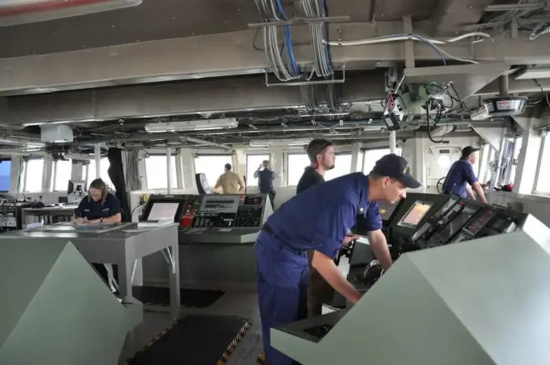 Officer at the controls on a ship’s bridge